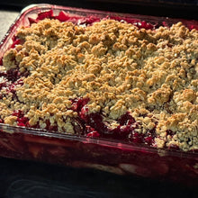 Baked apple & wild blueberry dessert with crumbly topping in a glass dish