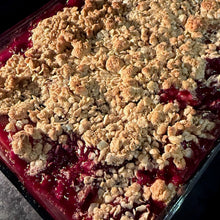 Baked apple & wild blueberry dessert with crumbly topping in a glass dish