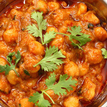 A bowl of sweet potato chana masala garnished with cilantro.
